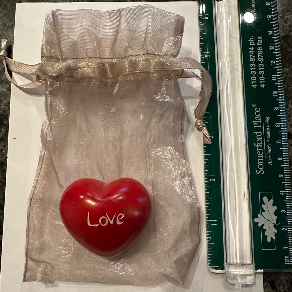 Weighty red heart shaped object with its own mesh bag.  Four available.